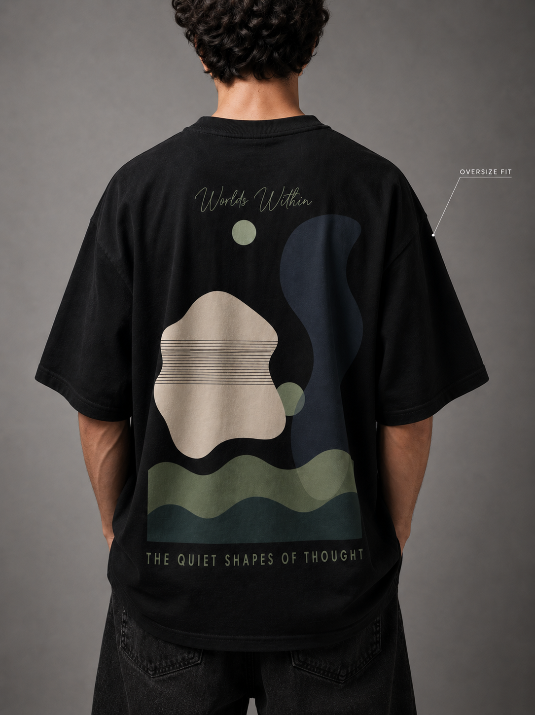 Person wearing a black t-shirt with abstract design and text on the back against a gray background